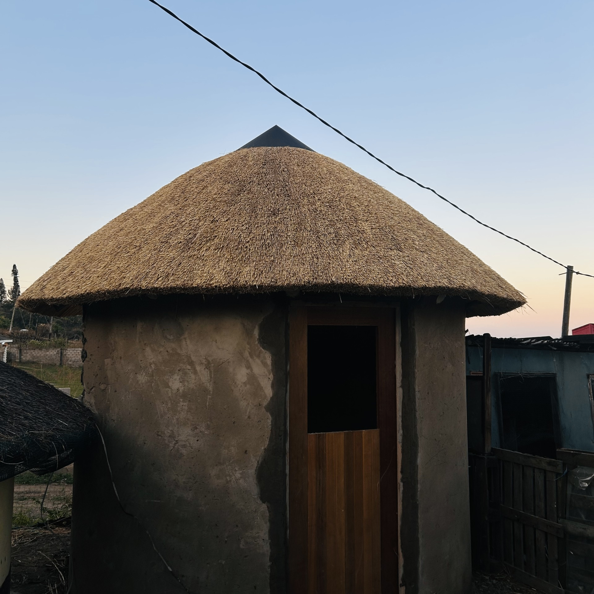 Freshly thatched rondavel with sharp conical peak